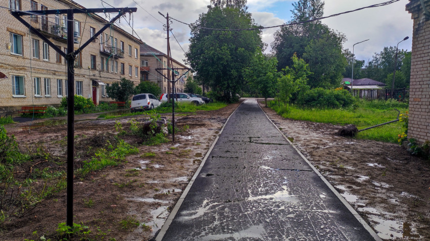 Тротуар во дворе многоквартирного дома после дождя