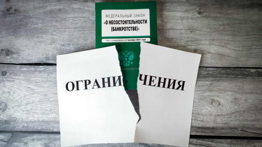 Закон о банкротстве и лист с надписью «Ограничения»