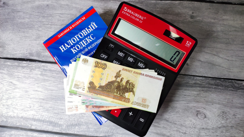 Налоговый кодекс России, калькулятор и российские купюры на столе