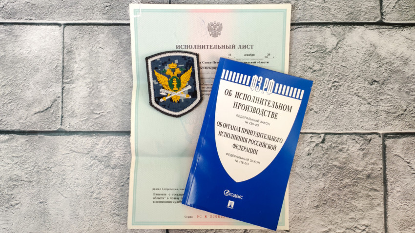 Закон об исполнительном производстве и документ с шевроном ФССП