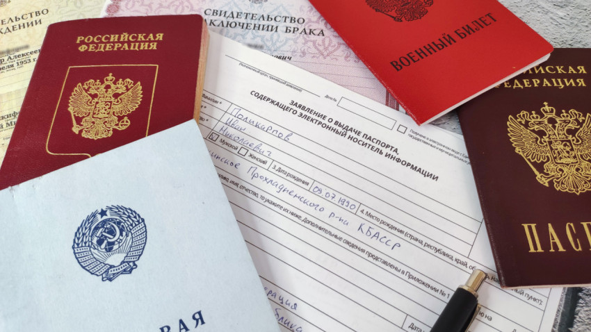 Паспорт, заявление и военный билет на фоне официальных свидетельств
