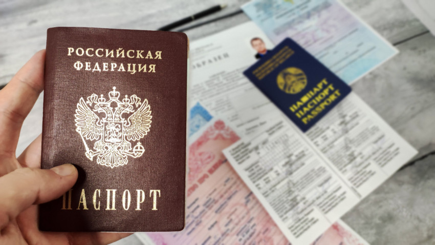 Паспорт Российской Федерации и иностранный паспорт на фоне документов