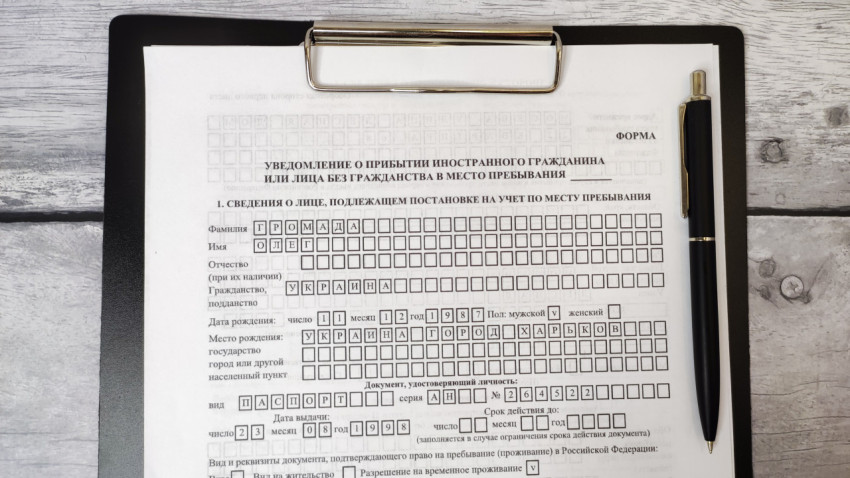 Уведомление о прибытии с заполненными данными и ручкой на планшете