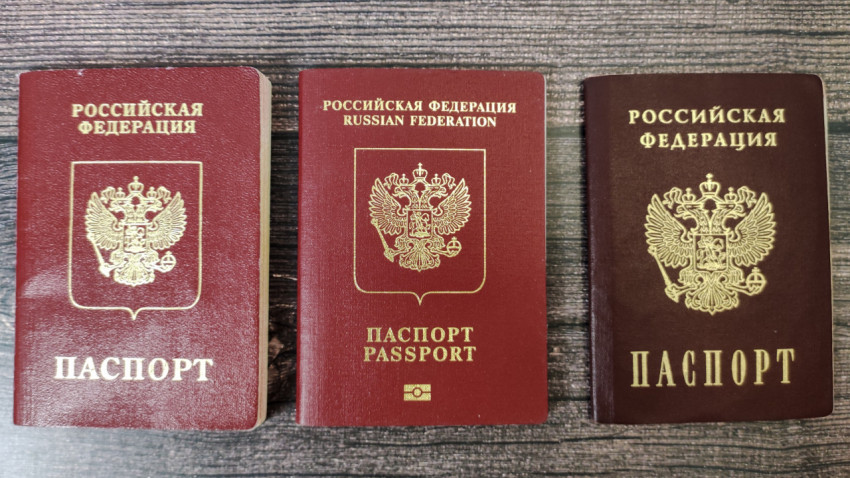 Три паспорта Российской Федерации на деревянной поверхности