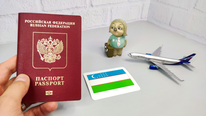 Российский загранпаспорт, флаг Узбекистана и модель самолета