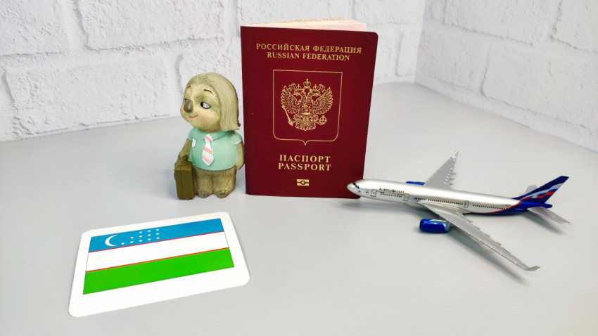 Российский заграничный паспорт, карта с флагом Узбекистана и модель самолета