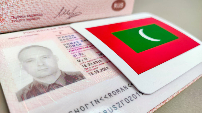 Загранпаспорт РФ и флаг Мальдив крупным планом