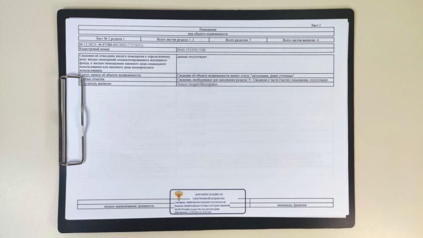 Страница выписки ЕГРН о статусе жилого помещения на клипборде