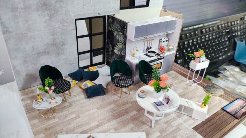 Миниатюрная модель современной гостиной с кухней и мебелью