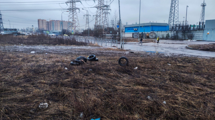 Заброшенная территория с выброшенными шинами под ЛЭП