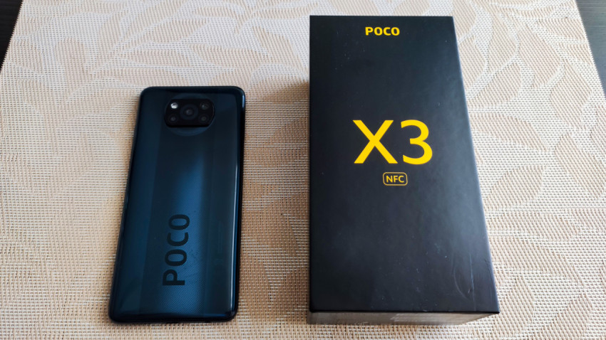 Смартфон POCO X3 NFC и фирменная коробка на столе