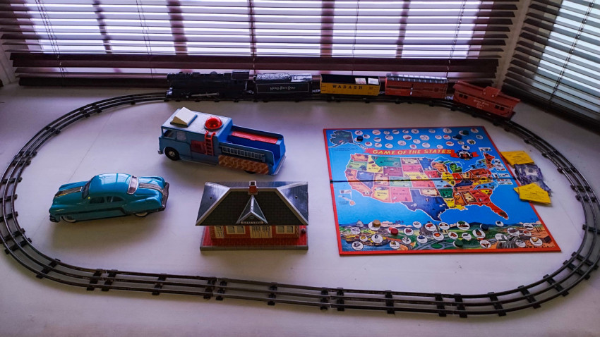 Макет железной дороги с игрушечным поездом и настольными играми