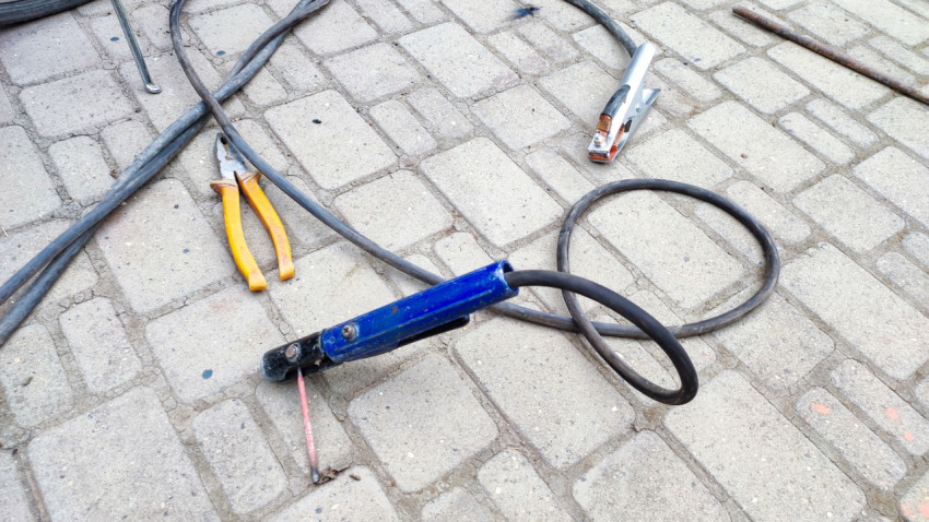 Сварочный электрододержатель и ручной инструмент на тротуаре