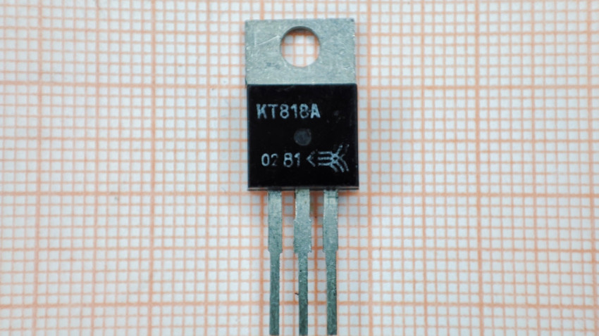 Фронтальный вид транзистора КТ818А на фоне миллиметровой бумаги