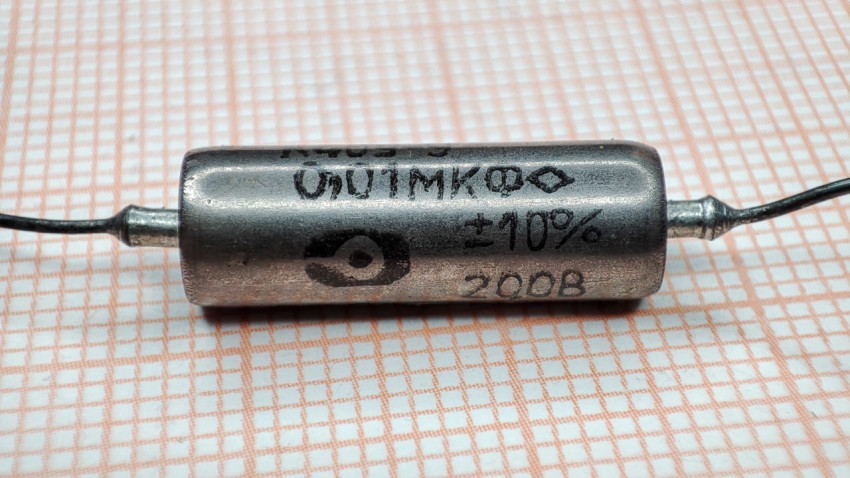 Крупный план конденсатора К40У-9 с маркировкой 0,01 мкФ 200 В