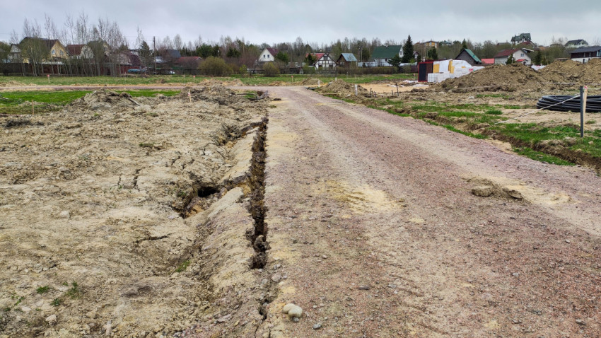 Зарытая траншея после укладки труб на строительной площадке