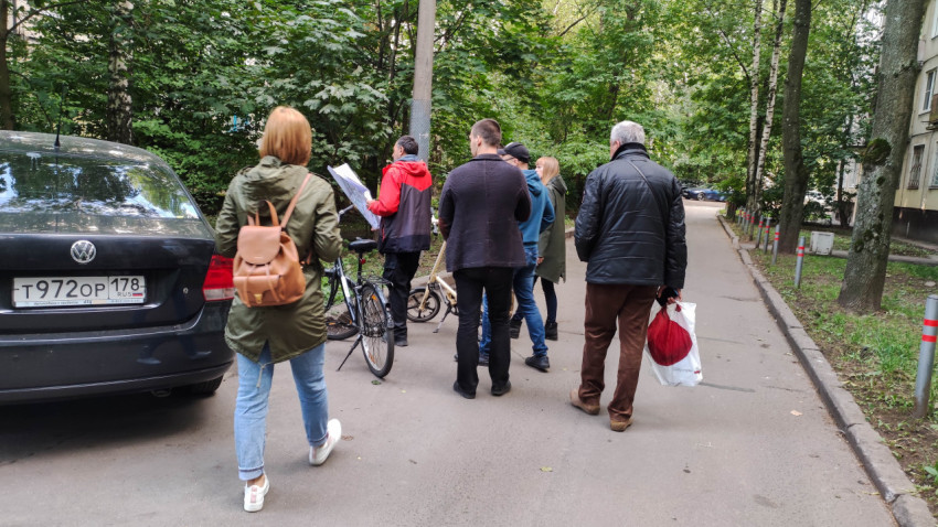 Группа людей обсуждает проект благоустройства с картой