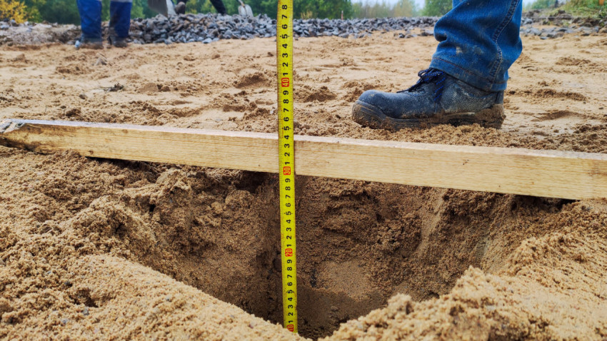Измерение глубины основания дороги на стройплощадке