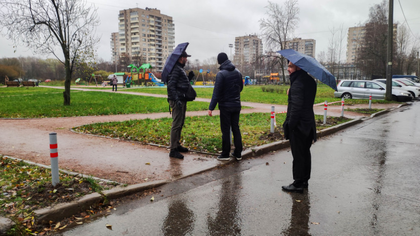 Группа людей обсуждает благоустройство территории возле детской площадки