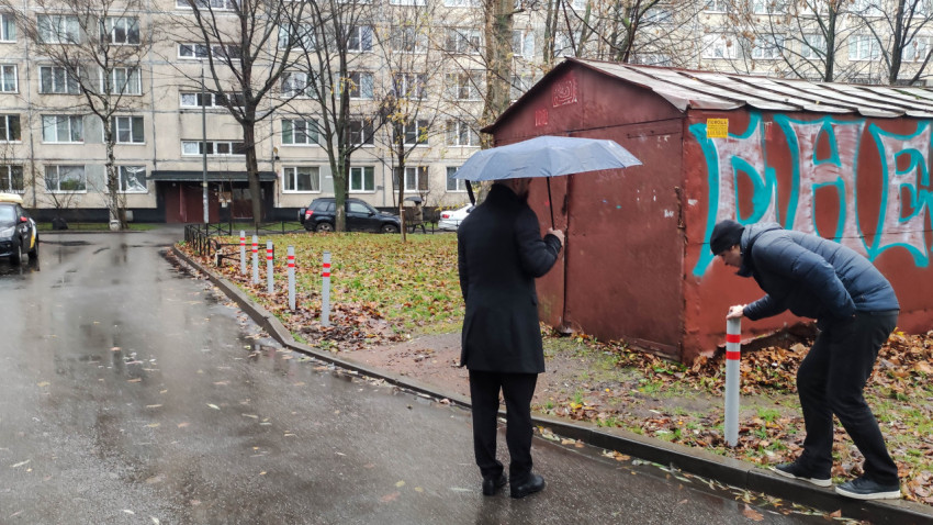 Осмотр состояния антипарковочных столбиков возле гаража в жилом дворе