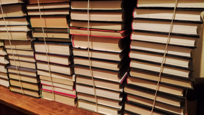 Стопки связанных книг на деревянной поверхности