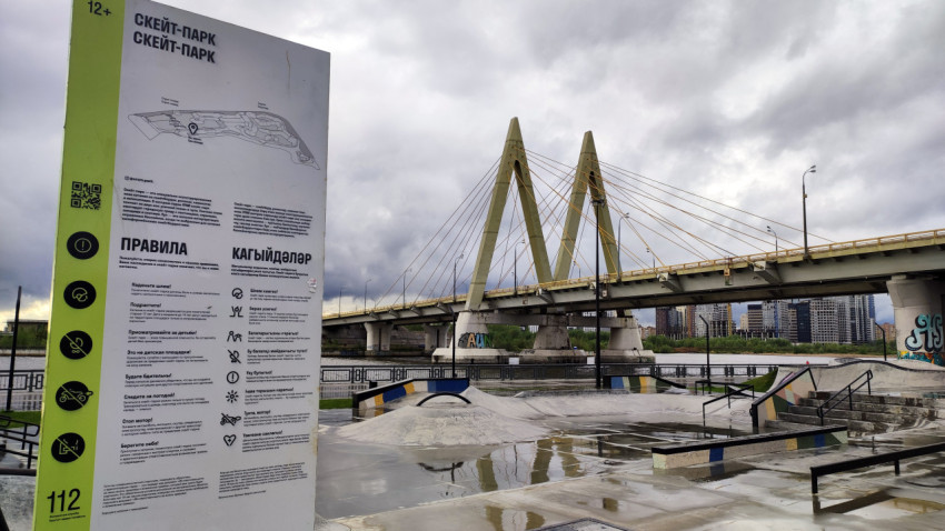 Информационный щит скейт-парка с мостом Миллениум на заднем плане