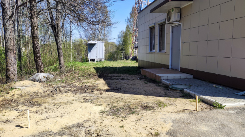 Задний двор здания с техническим блоком и антенной