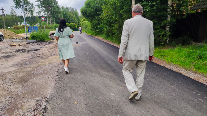 Люди на загородной дороге после укладки асфальта