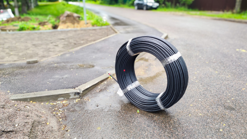 Свернутый кабель на асфальте во время строительства