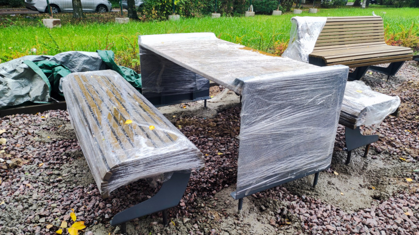 Новая уличная мебель, упакованная в защитную плёнку перед установкой