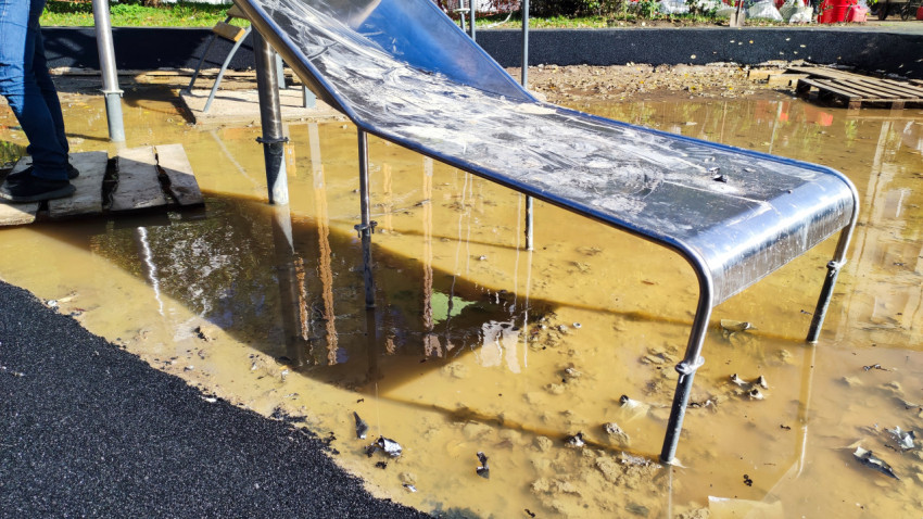 Металлическая горка на детской площадке после дождя