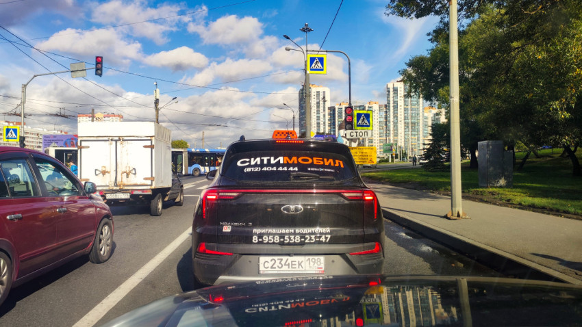 Городской перекрёсток с автомобилями и светофором в дневное время