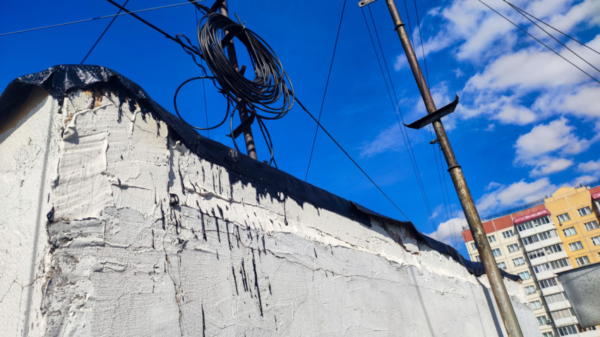 Стена здания с битумными следами и проводами