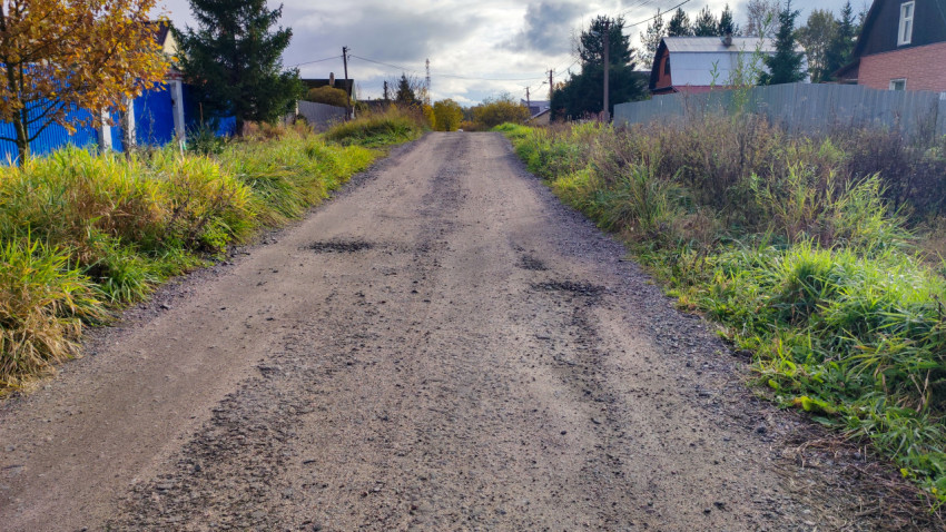 Сельская дорога с ямами и неровным щебёночным покрытием
