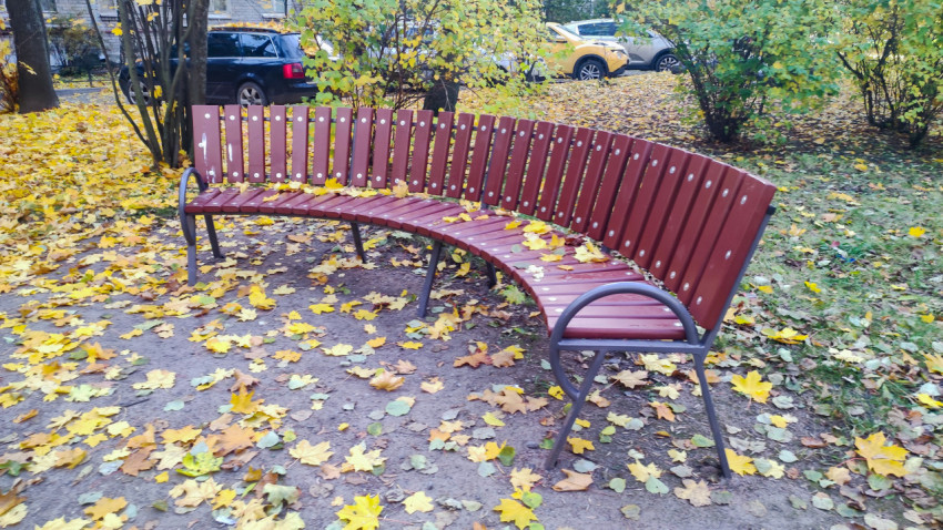 Уличная скамья на придомовой территории в осенний период