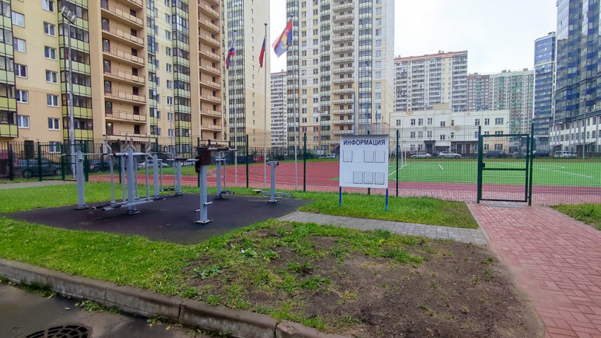 Уличные тренажёры и спортивное поле во дворе жилого комплекса