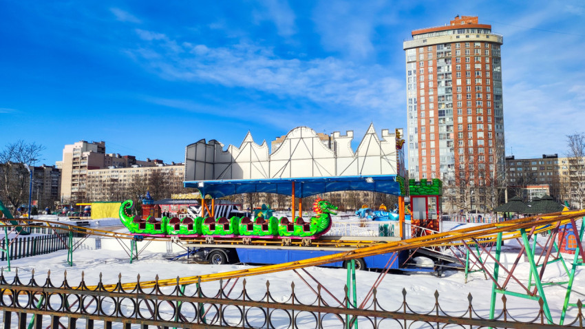 Детский аттракцион и жилой дом на заднем плане