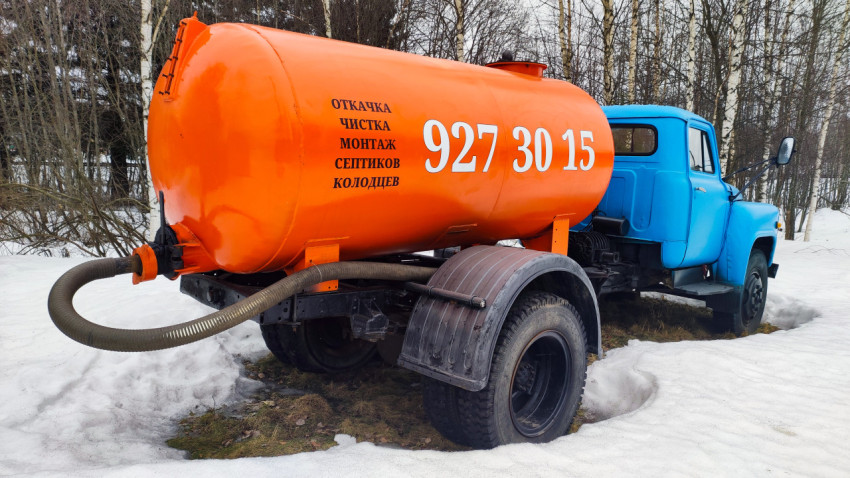 Коммунальный грузовик ЗИЛ с оранжевой цистерной в снегу