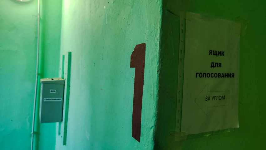Подъезд с табличкой и указателем к ящику для голосования