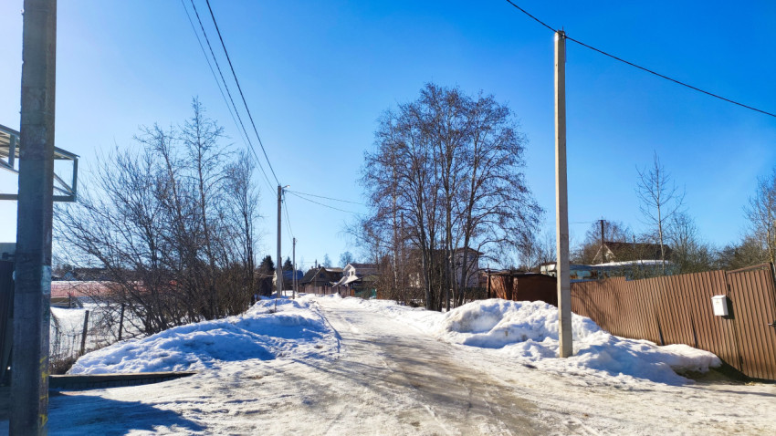 Зимняя улица с электролиниями и частной застройкой