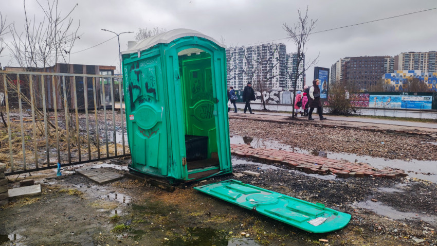 Разбитая передвижная туалетная кабина на городской улице