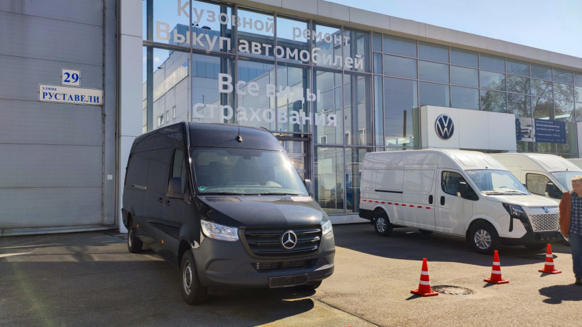 Фургоны Mercedes-Benz и Volkswagen у здания автосалона на улице Руставели