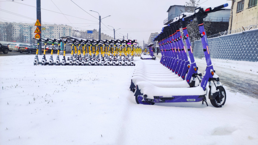 Электросамокаты Whoosh и Юрент под снегом напротив жилой застройки