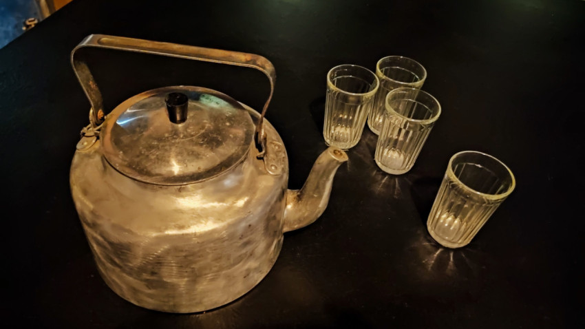 Металлический чайник и гранёные стаканы на столе в павильоне «АТОМ»