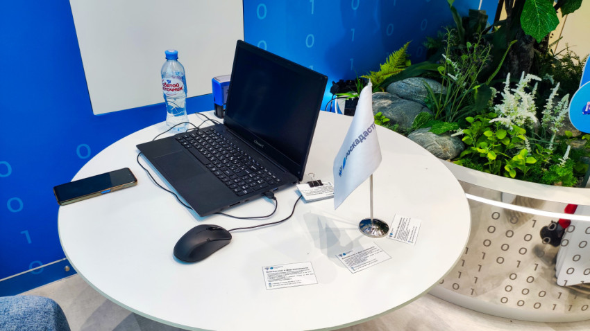 Рабочая зона с ноутбуком и символикой Роскадастра на выставке