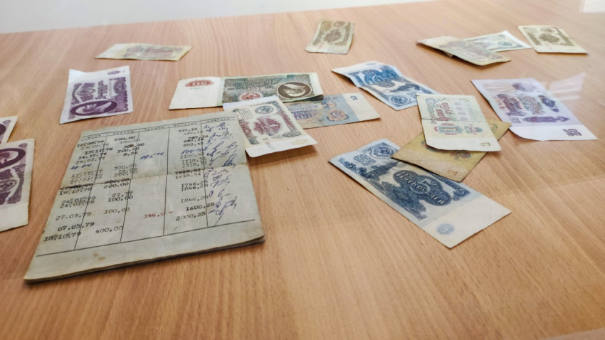 Разложенные советские купюры и раскрытая сберкнижка СССР