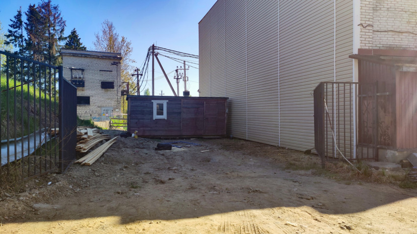 Строительная площадка между зданиями с временным деревянным сооружением