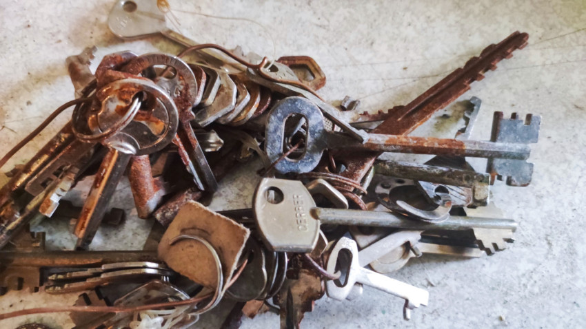 Связка ключей с коррозией, проволокой и пластиковым ярлыком на полу