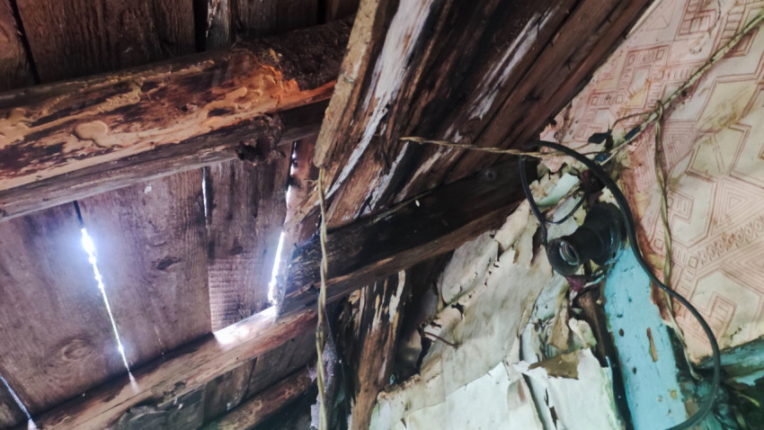 Поврежденный потолок и электропроводка в заброшенном доме