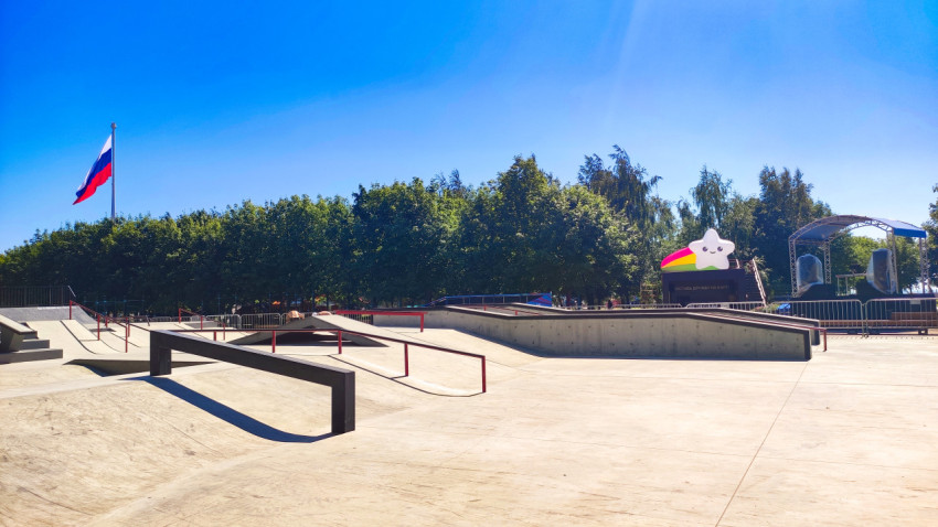 Скейтпарк с рейлами, флагом и сценой с надувной звездой на заднем плане